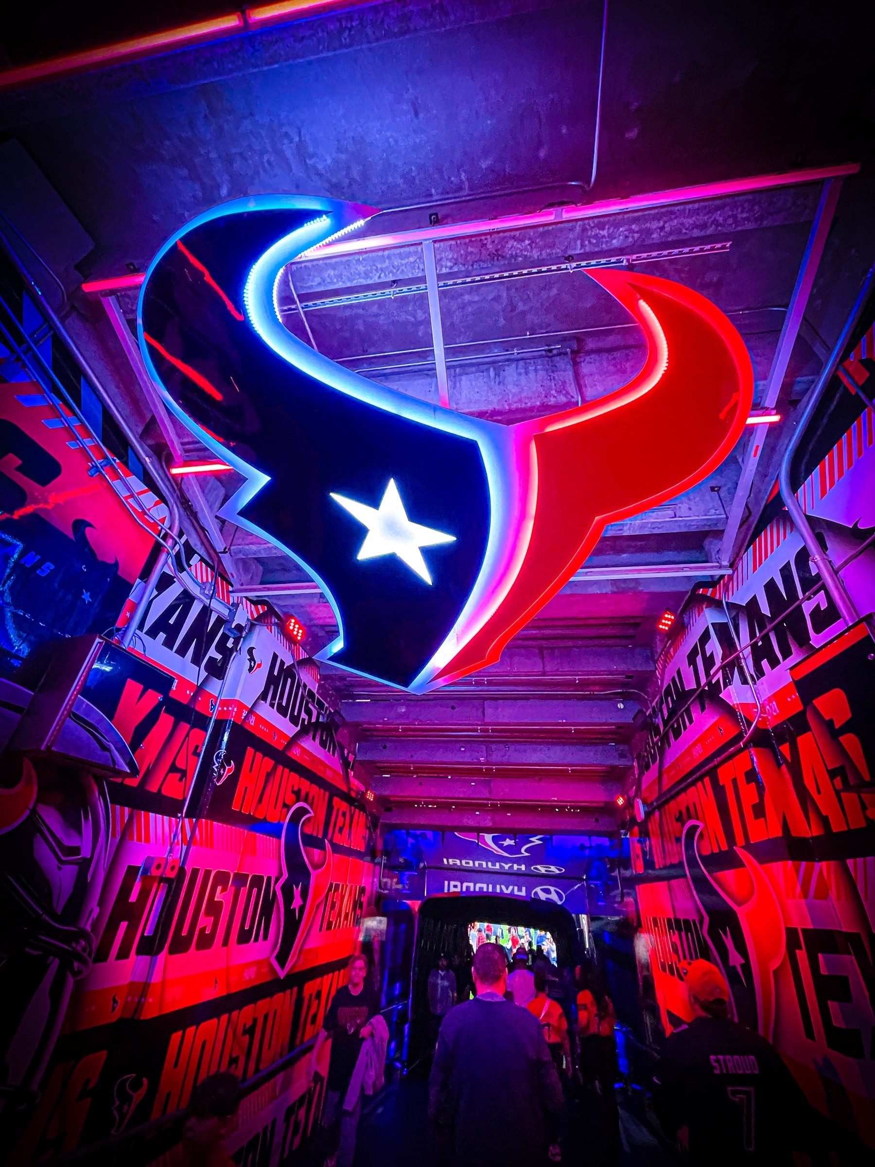 A blue and red neon bull-head sign inside a brightly lit interior.
